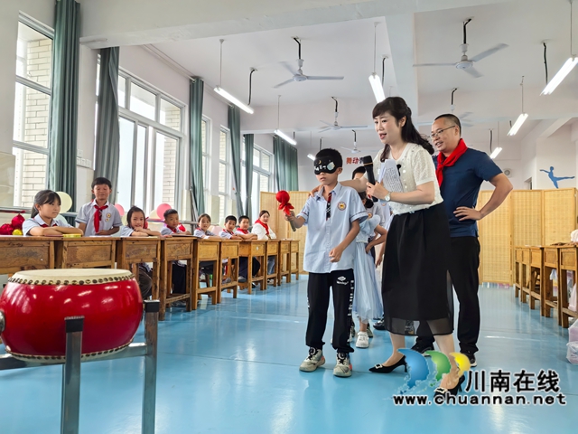 瀘縣農(nóng)民工服務(wù)中心工作人員帶著孩子們玩“敲大鼓”游戲.jpg